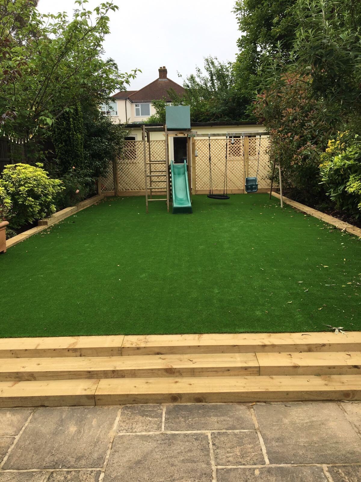 Artificial grass lawn with sleeper steps in Surrey