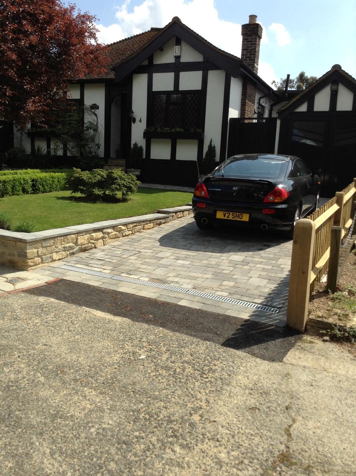 Block paving driveway with circle feature at dusk in Surrey