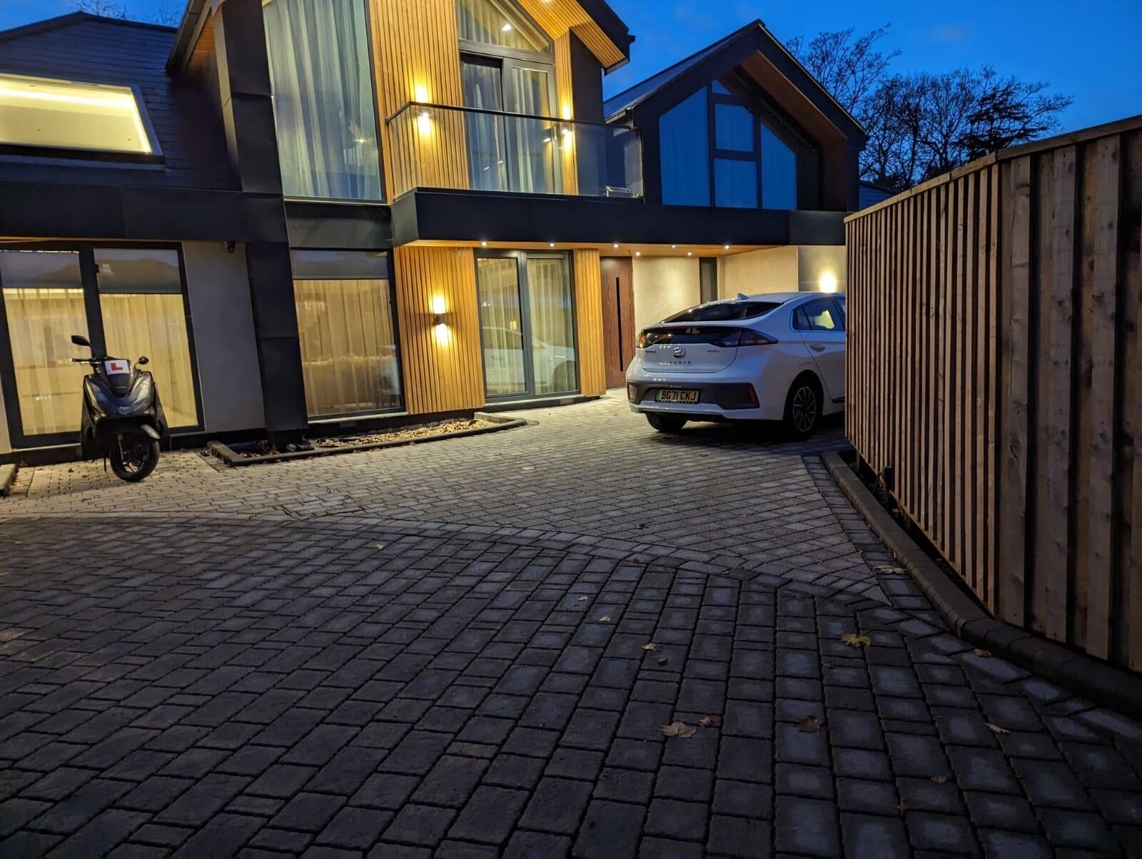 Modern home with block paving driveway at dusk in Surrey