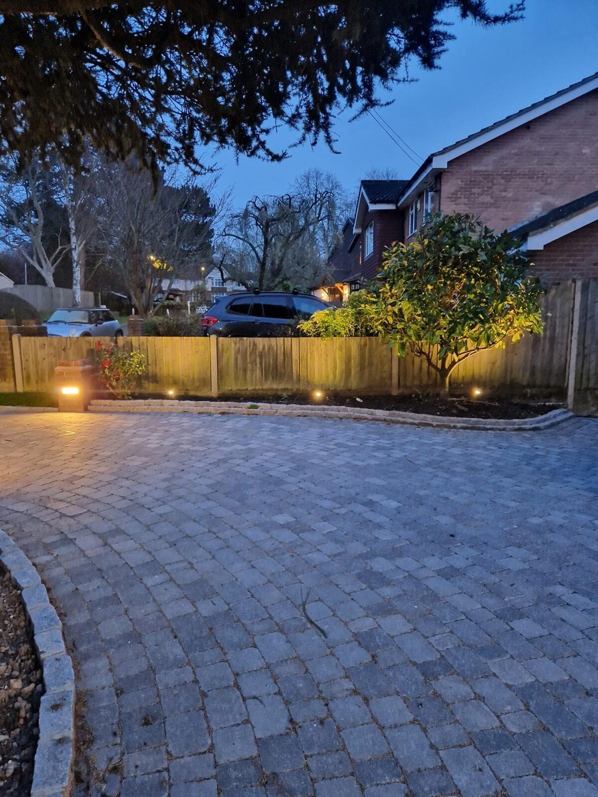 Block paving driveway with lighting at dusk in Surrey