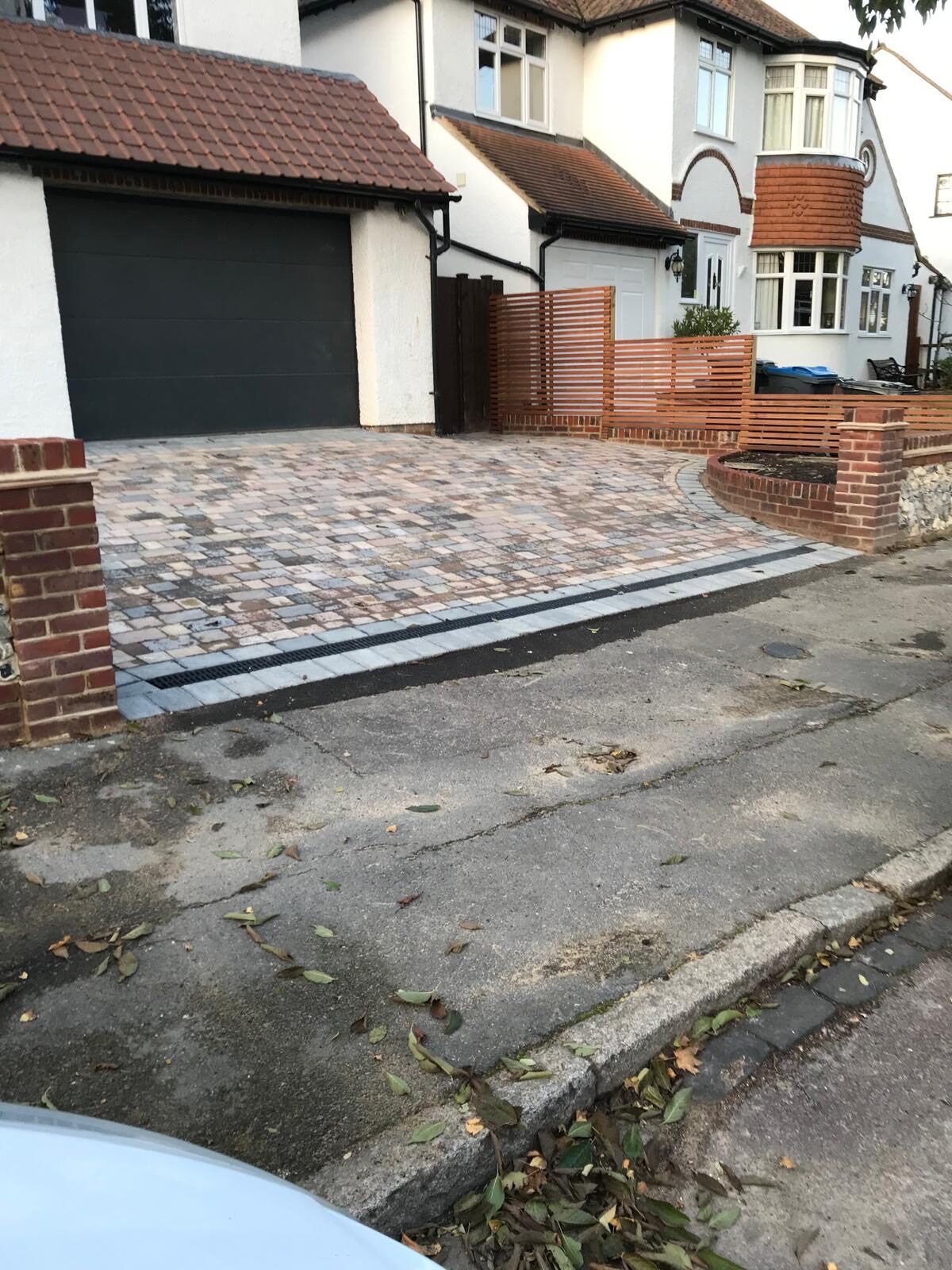 Charcoal block paving driveway to a modern garage in Surrey
