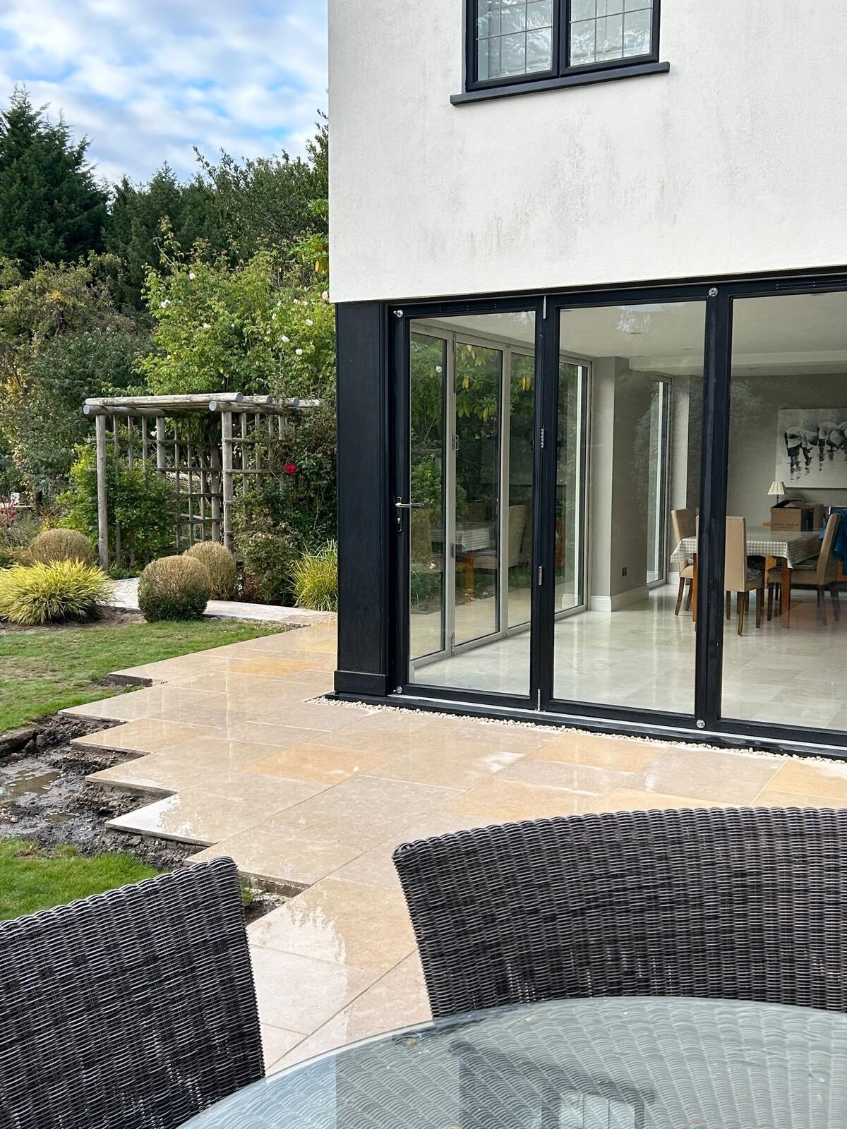 Contemporary porcelain patio beside bifold doors in Surrey