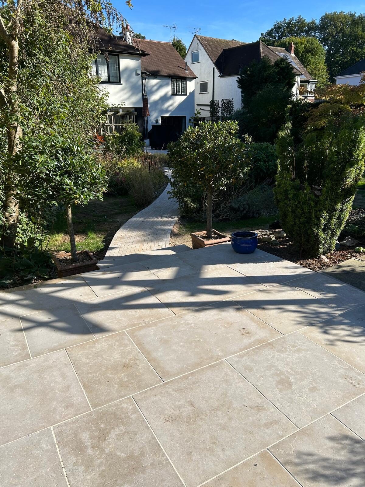 Grey porcelain patio with bifold doors in Surrey