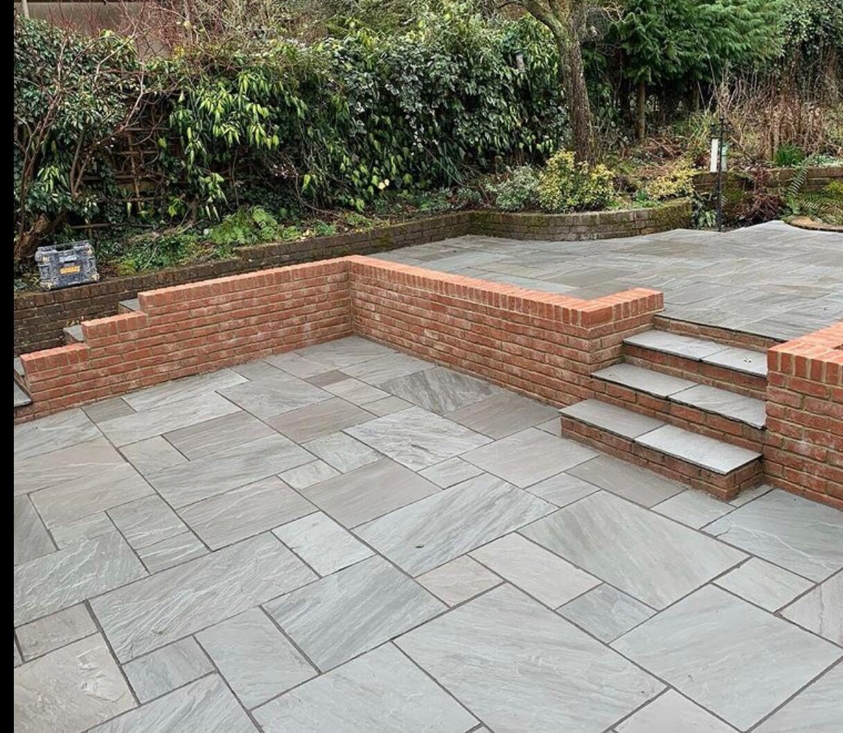 Grey porcelain patio with border in Surrey