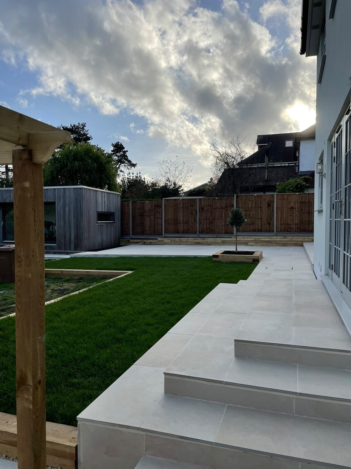 Grey porcelain patio with lawn in Surrey