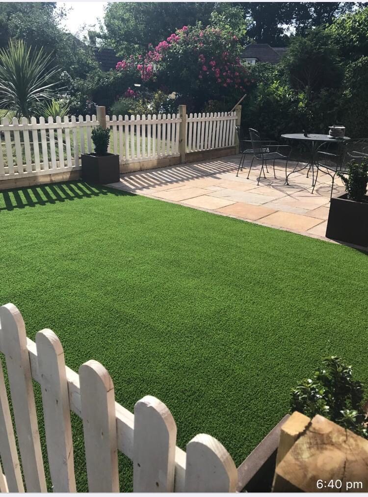 Freshly laid lawn with striped turf and patio in Surrey