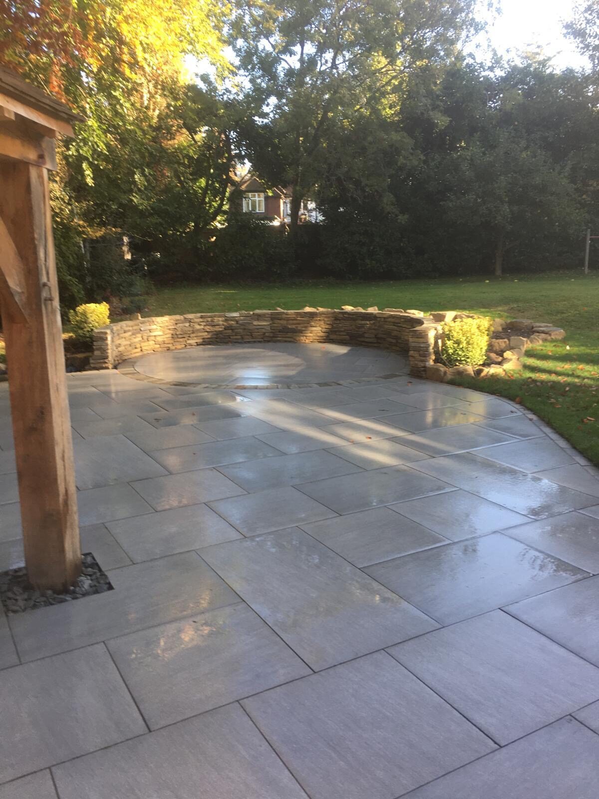 Covered patio with pergola and lighting at dusk in Surrey