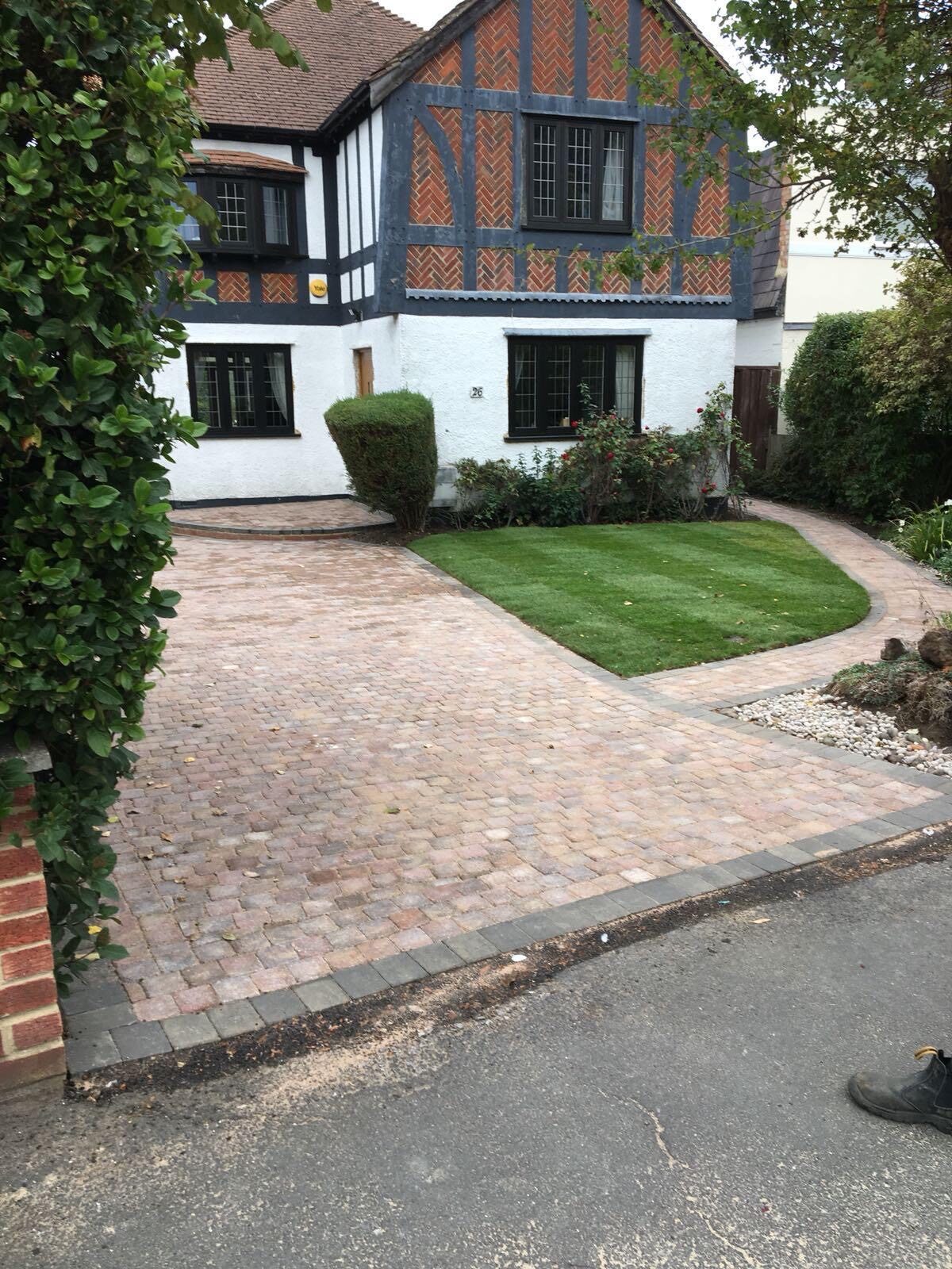 Red block paving driveway with fencing in Surrey