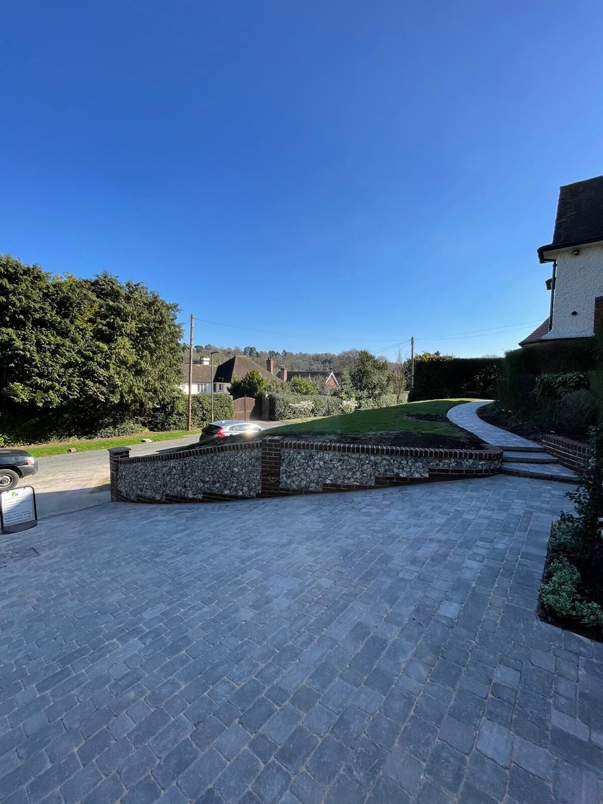 Sweeping block-paved driveway with lawn edging in Surrey